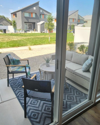 Picture of a back patio as seen looking through a sliding glass door. 