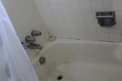 Image of a moldy and damaged bathtub 